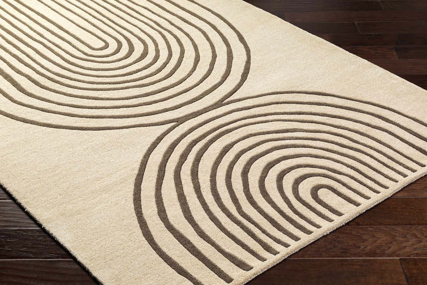 Close-up of the Fuat Beige Area Rug, a hand-tufted wool rug with a contemporary arch pattern in beige and dark brown. Corner