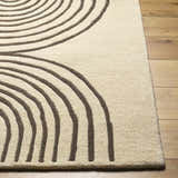 Close-up of the Fuat Beige Area Rug, a hand-tufted wool rug with a contemporary brown concentric circle design. Front