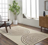 Living room scene with a Fuat Beige Area Rug, gray chair, wood cabinet, and large window. Roomscene-Rectangle