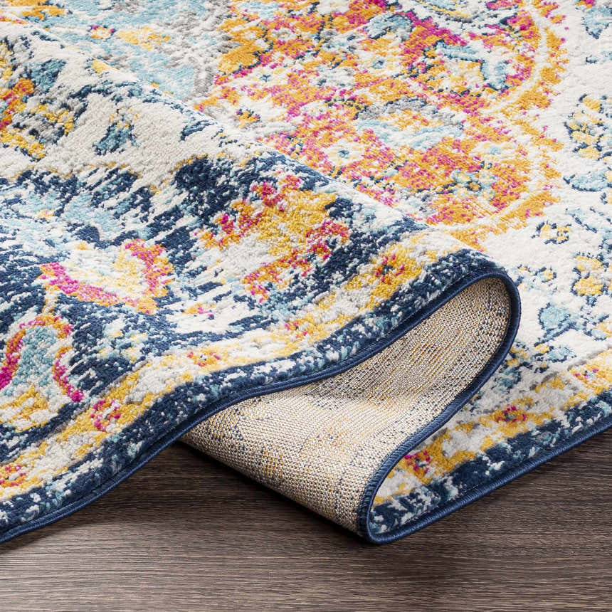 Close-up of the Silkstone Area Rug showing its aqua, cream, dark blue, fuchsia, and saffron colors and machine-woven texture. Fold