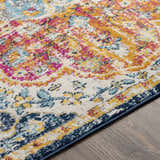 Close up of the Silkstone Area Rug showing its aqua, cream, saffron, and fuchsia traditional design. Texture