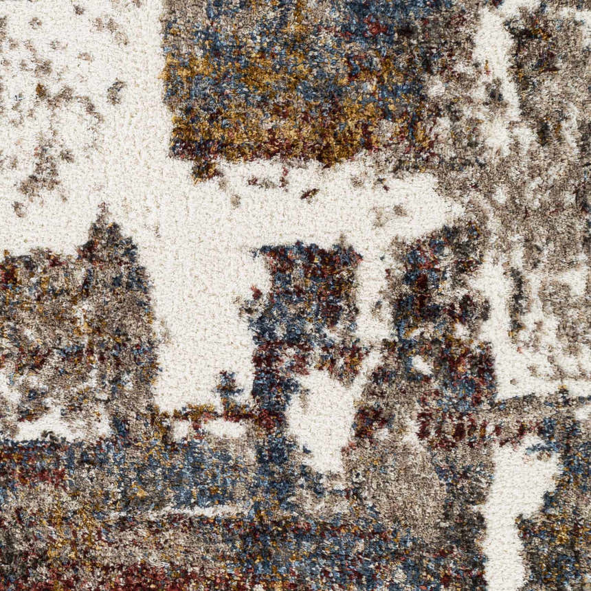 Close up of the Silvis Boutique Area Rug. Shag texture with burgundy, blue, cream, and mustard colors. Swatch
