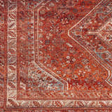Close-up of the Siocon Washable Area Rug showing its traditional, intricate pattern and rich red, blue, and cream colors. Swatch