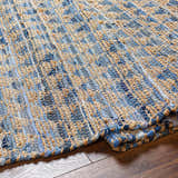 Close-up of the Colm Recycled Blue Jean Rug. Hand-woven rug with blue denim and tan jute texture. Contemporary style. Fold