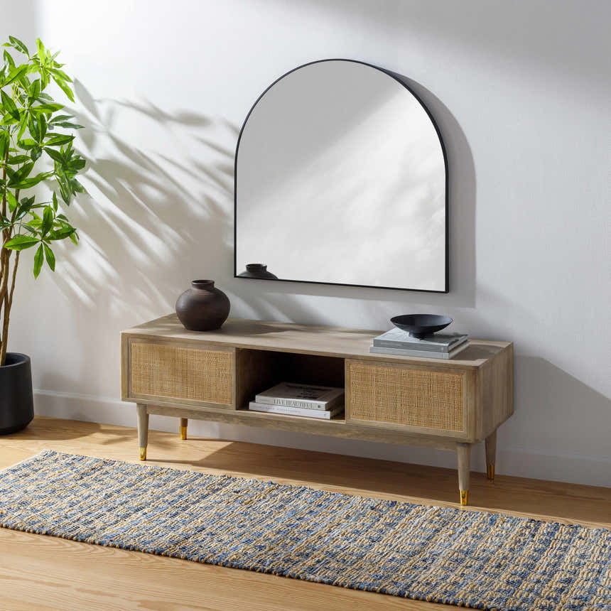 Living room scene with Colm Recycled Blue Jean Rug, light wood console table, arched mirror, and potted plant. Roomscene-Runner