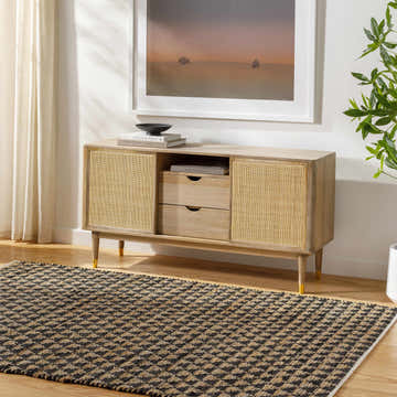Living room scene with a Colm Recycled Black Jean Rug, light wood console table, neutral walls, and natural light. Roomscene-Rectangle