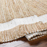 Close-up of the hand-woven Ghita White Area Rug, showing the jute and recycled fabric texture and dark beige and white colors. Fold