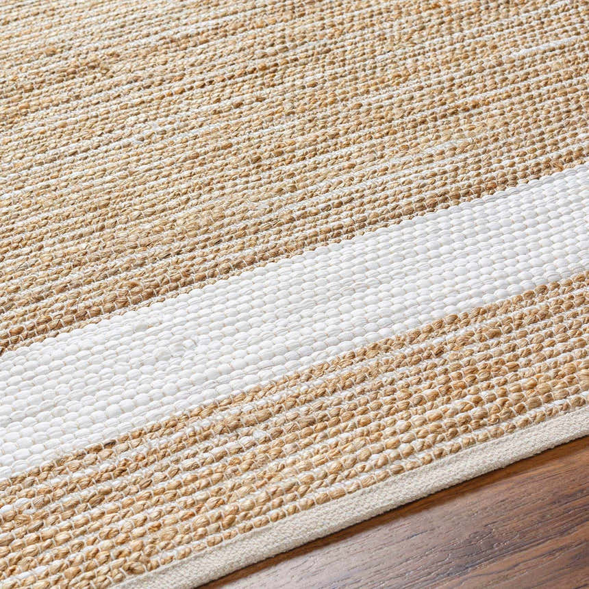 Close-up of the hand-woven Ghita White Area Rug. Jute and recycled fabric rug with dark beige and white stripes. Contemporary style. Texture