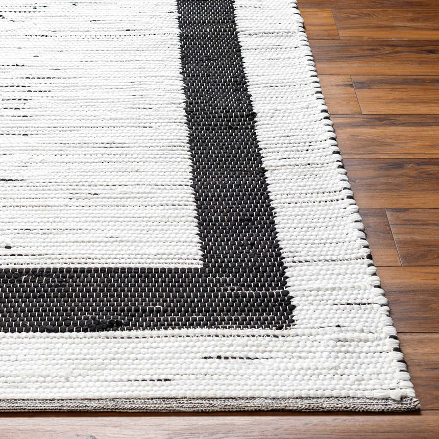 Close-up of the hand woven Jaden Area Rug. Charcoal and off white contemporary design with jute and recycled fabric texture. Front