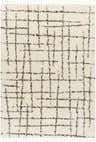 Close-up of the Hodor Area Rug: a beige shag rug with a gray grid pattern and tassel fringe. Farmhouse style. Design-Rectangle-537