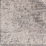 Close-up of the Azibo Area Rug showing its traditional pattern and texture in black, gray, taupe and brown tones. Swatch