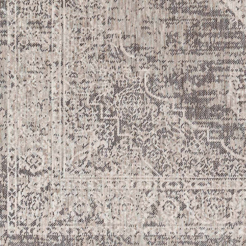 Close-up of the Azibo Area Rug showing its traditional pattern and texture in black, gray, taupe and brown tones. Swatch