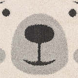 Close-up of the Kids Bear Animal Print Nursery Area Rug, featuring a cute bear face in bone, dark gray, and black. Swatch