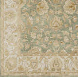 Close-up of the hand-knotted Skipwith Area Carpet. Features a traditional floral design in sage green and cream tones. Swatch