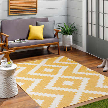 Patio scene with Anke Yellow Area Rug, gray loveseat, and white accent table. Farmhouse style. Roomscene-Rectangle