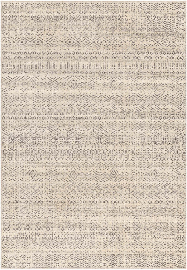 Close-up of the Truc Area Rug, a machine-woven rug with a bone base and cloud gray, bohemian-inspired geometric patterns. Design-Rectangle-537