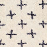 Close-up of the Bede Washable Area Rug. Beige shag rug with a charcoal plus sign geometric pattern. Soft, textured rug detail. Swatch