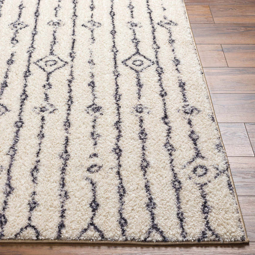 Close-up of the Demi Beige Washable Area Rug. Features a shag texture and a vertical geometric pattern. Front