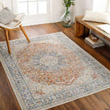 Living room scene with Emke Rust Washable Area Rug in dark beige, gray, and nutmeg colors, styled with a white chair and wood bench. Roomscene-Rectangle