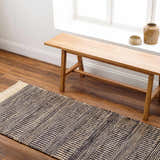 Entryway with wood bench and Black Elle Area Rug, a black and beige jute runner with geometric pattern. Roomscene-Runner