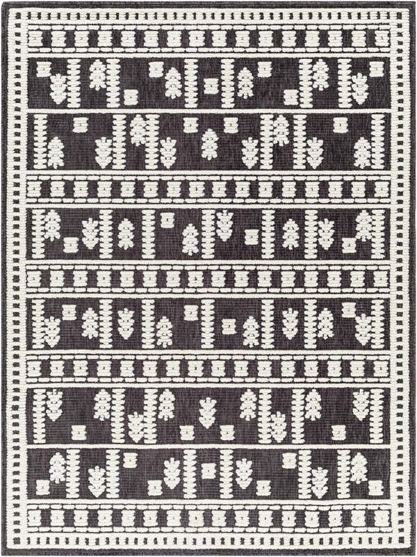 Close-up of the Yama Washable Area Rug. Dark gray rug with a geometric, Scandinavian-inspired pattern in white. Machine woven texture. Design-Rectangle-57