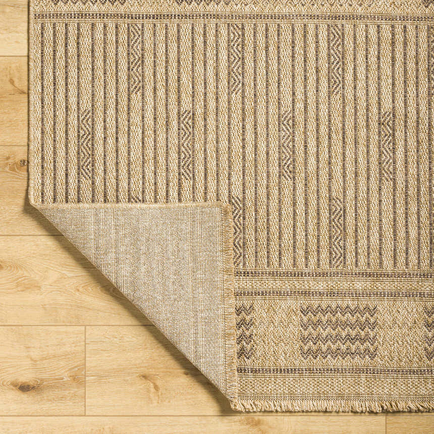 Close-up of the Gerik Faux Jute Rug showing its lambswool and light brown colors, vertical stripes, and geometric pattern. Fold