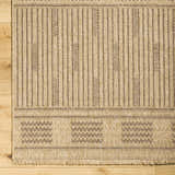 Close-up of Gerik Faux Jute Rug. Lambswool and light brown rug with farmhouse style stripes and geometric pattern. Corner