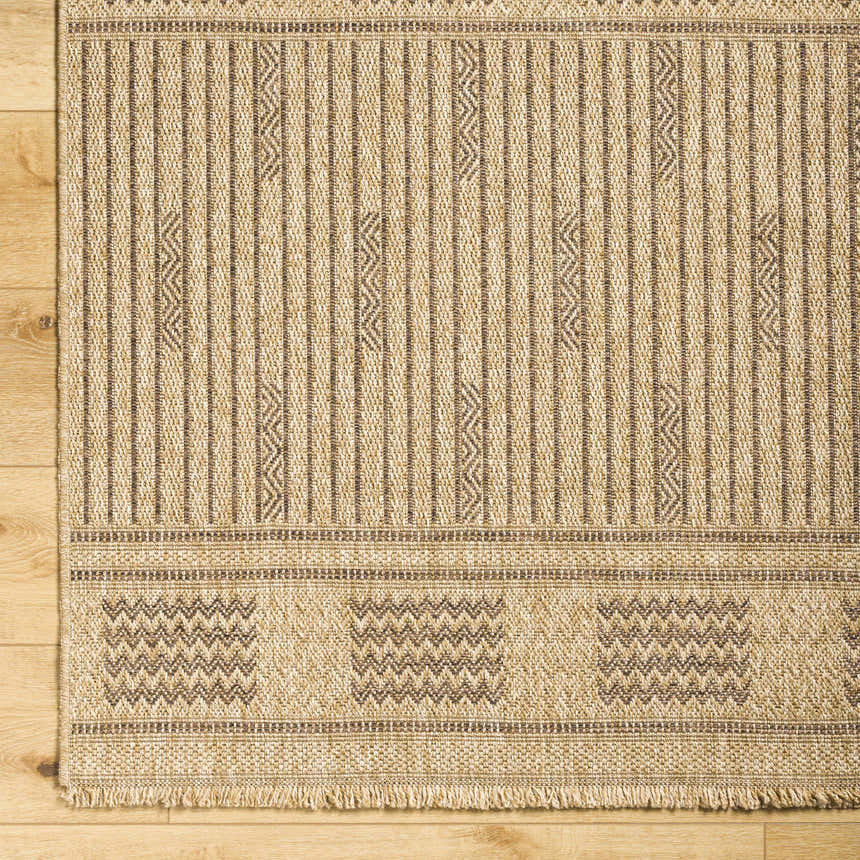 Close-up of Gerik Faux Jute Rug. Lambswool and light brown rug with farmhouse style stripes and geometric pattern. Corner