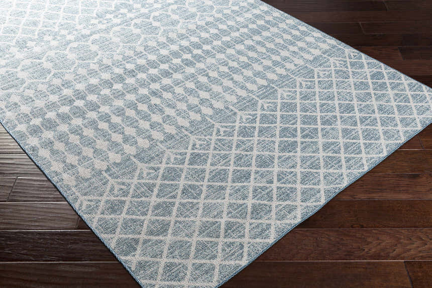 Close-up of the Blue Ivory Summit Indoor & Outdoor Area Rug showing its geometric pattern and colors. Corner