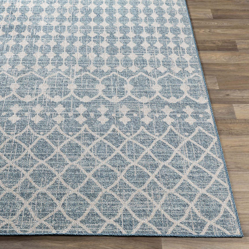 Close-up of Blue Ivory Summit Indoor Outdoor Area Rug showing geometric pattern and texture on wood floor. Front