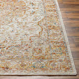 Close-up of the Aman Beige Area Rug showing its traditional design, brick red, mustard, and navy colors on a wood floor. Front