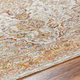 Close-up of the Aman Beige Area Rug showing its traditional pattern in brick red, mustard, navy, and light sage colors. Texture