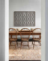 Farmhouse dining room with wood table and chairs on a Duong Beige Textured Rug. White walls and natural light. Roomscene-Rectangle