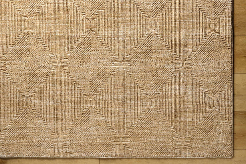Close up of the Dekan Tan Area Rug featuring a geometric diamond pattern and textured lambswool color. Corner