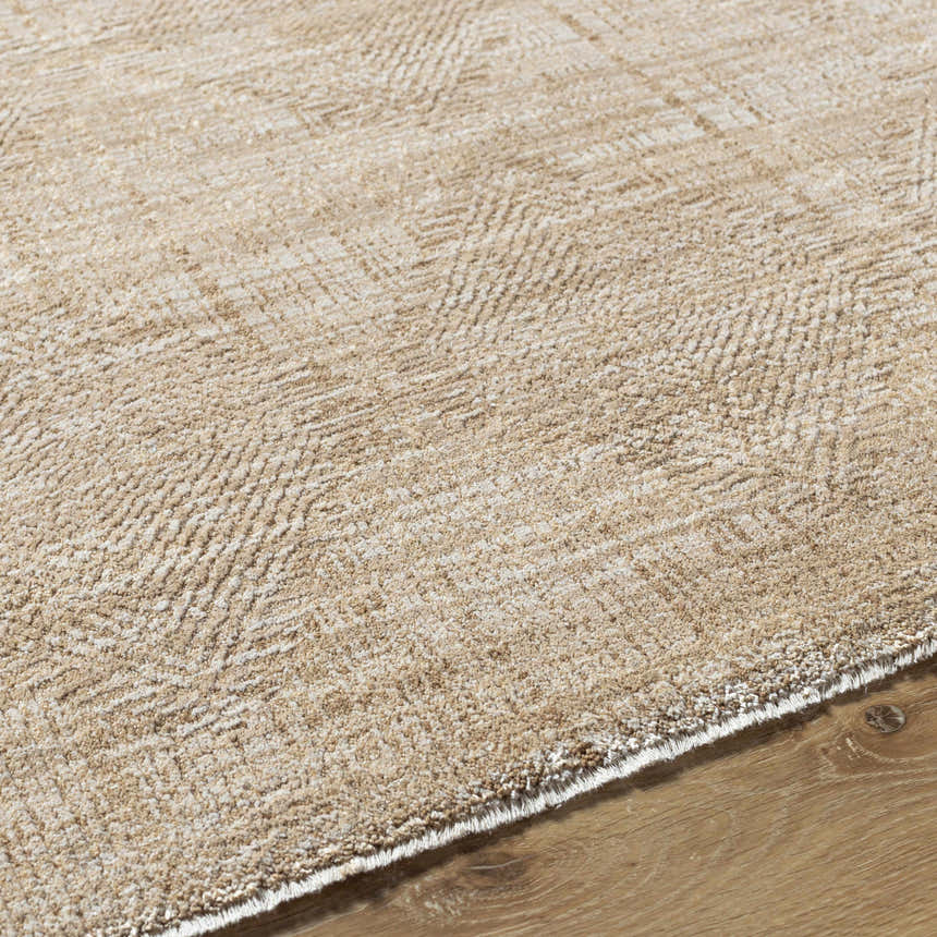 Close-up of the Dekan Tan Area Rug showing its subtle herringbone pattern and soft lambswool and light brown colors. Texture