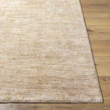Close-up of the textured Kahua Tan Area Rug on a wood floor, showing its neutral, farmhouse style. Front