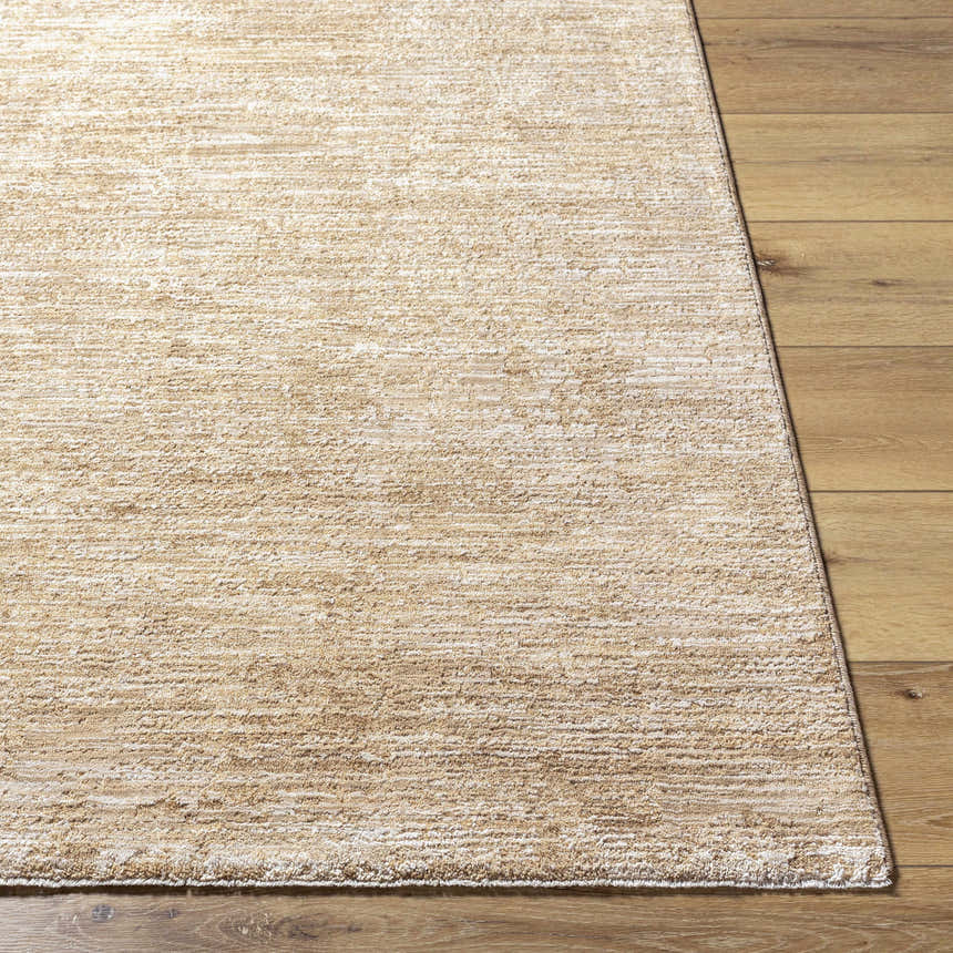 Close-up of the textured Kahua Tan Area Rug on a wood floor, showing its neutral, farmhouse style. Front