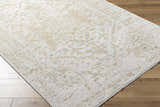 Close-up of the Sunee Luxe Rug in ash, pearl, and silver gray with a traditional pattern on hardwood floors. Corner