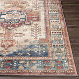 Close-up of the Snell Area Rug showing its traditional, Southwestern-inspired pattern and amber, brick red, and blue colors. Front