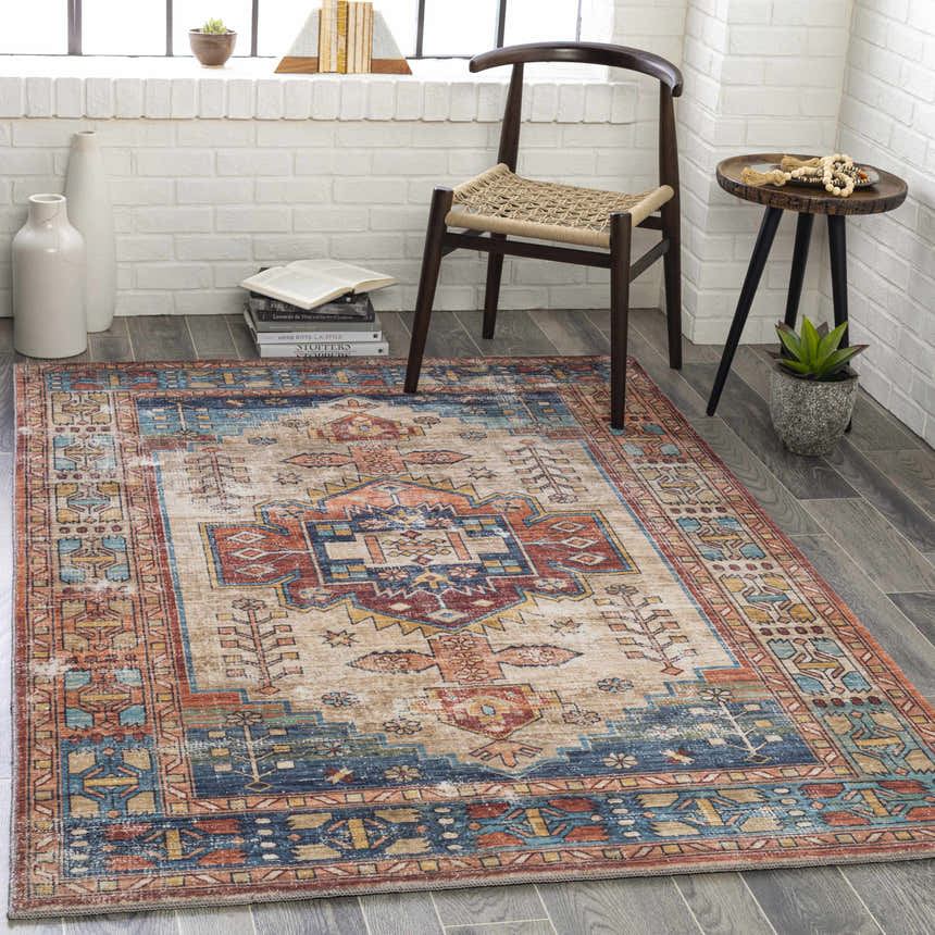 Entryway with Snell Area Rug in amber, brick red, and blue. Farmhouse style with chair, side table, and white brick wall. Roomscene-Rectangle