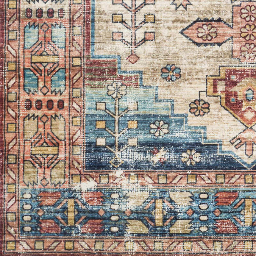 Close-up of the Snell Area Rug showing its traditional, Southwestern-inspired pattern in amber, blue, and brick red tones. Swatch