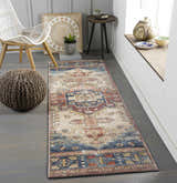 Hallway scene with a Snell Area Rug runner in amber, brick red, and blue. Farmhouse style with chair, pouf, and decor. Roomscene-Runner