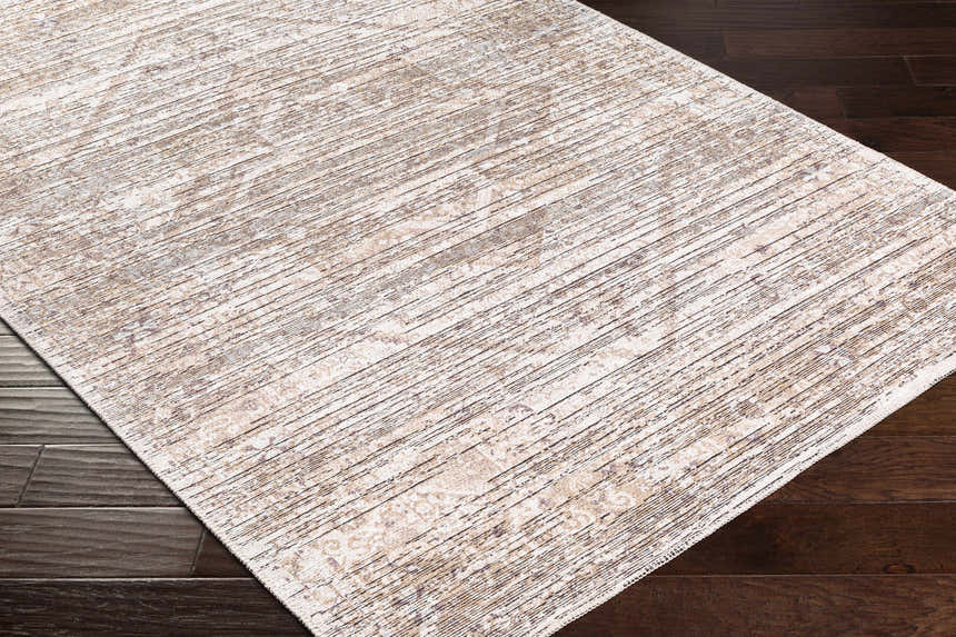 Close-up of the Elisa Area Rug on dark wood flooring. The rug has a striped pattern in lambswool, taupe, and brown. Corner