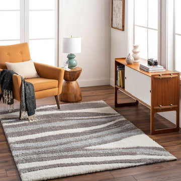 Living room scene with a gray and white striped Hasad Area Rug, mustard chair, and mid-century modern cabinet. Roomscene-Rectangle