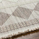 Close up of the Igone Area Rug showing beige and brown geometric pattern and textured fringe. Texture