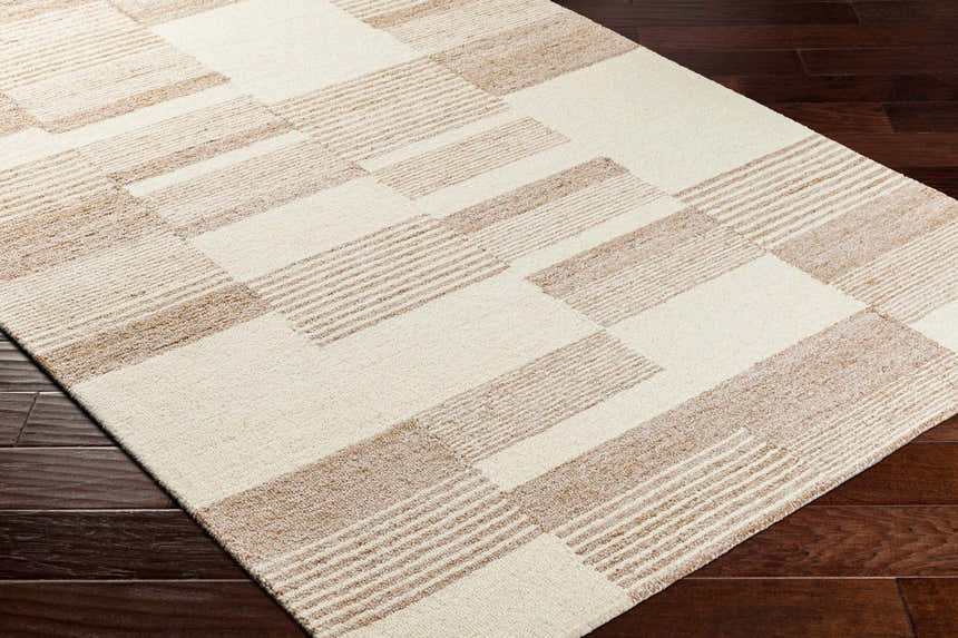 Close-up of the Eyad Area Rug. Beige and brown geometric pattern on a hand-tufted, wool and recycled PET yarn rug. Corner