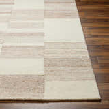 Close up of the Eyad Area Rug showing beige and bone geometric pattern and wool texture. Front