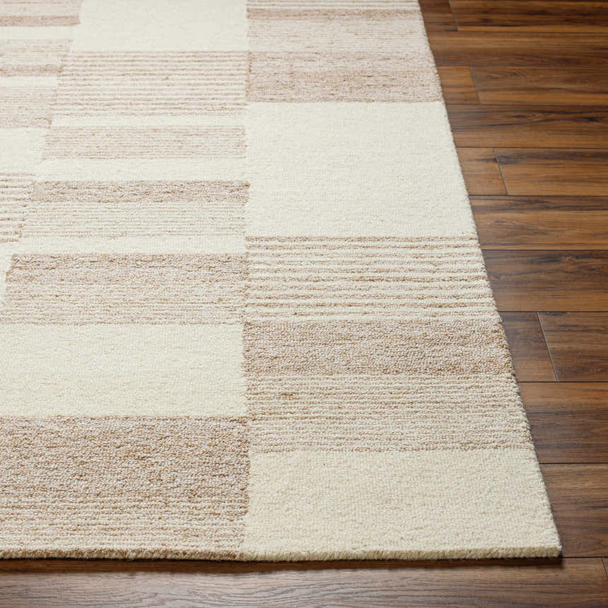 Close up of the Eyad Area Rug showing beige and bone geometric pattern and wool texture. Front