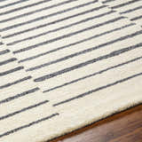 Close-up of Gawel Charcoal Area Rug showing beige wool and dark gray striped contemporary design. Texture