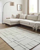 Living room with a beige sectional and Fusao Rose Cream Area Rug featuring a geometric pattern. Roomscene-Rectangle